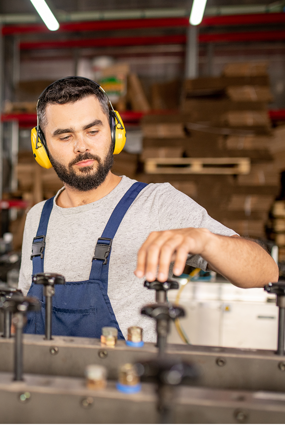 Person wearing headphones working on machinery